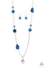 Load image into Gallery viewer, A collection of faceted blue gems, opaque blue beads, and polished silver beads trickle down a shimmery silver chain for a glamorous look. A lobster clasp hangs from the bottom of the design to allow a name badge or other item to be attached. Features an adjustable clasp closure. Sold as one individual lanyard. Includes one pair of matching earrings.