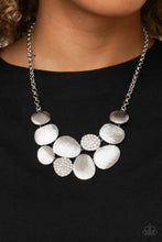 Load image into Gallery viewer, Featuring imperfect oval shapes, a series of delicately scratched and white rhinestone encrusted frames connect into a clustered pendant below the collar for a refined flair. Features an adjustable clasp closure. Includes one pair of matching earrings.