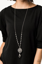 Load image into Gallery viewer, A collection of glassy and opaque white beads trickle down the bottom of a lengthened silver chain. Dotted with opalescent white rhinestones, a floral medallion-like pendant swings from the bottom for a whimsical finish. A lobster clasp hangs from the bottom of the design to allow a name badge or other item to be attached. Features an adjustable clasp closure. Sold as one individual lanyard. Includes one pair of matching earrings.