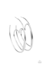 Load image into Gallery viewer, Glistening silver wire delicately bends into an airy heart frame inside a classic silver hoop, creating a flirtatious display. Earring attaches to a standard post fitting. Hoop measures approximately 2" in diameter. Sold as one pair of hoop earrings.