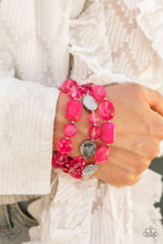 Load image into Gallery viewer, Glassy and opaque Raspberry Sorbet crystal-like beads and textured silver accents are threaded along stretchy bands around the wrist, creating vivacious layers.
