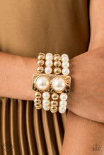 Load image into Gallery viewer, Held in place with a hammered gold frame dotted with two oversized white pearls, strands of classic gold beads and white pearls are threaded along stretchy bands that wrap around the wrist in a glamorously layered look. Individual bracelet.