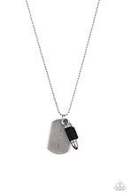 Load image into Gallery viewer, Pinched between a black leather fitting, a silver bullet pendant joins a silver dog tag at the bottom of a silver ball chain. The shimmery dog tag is stamped in the phrase, "Because of the Brave," for a patriotic finish. Features a ball and clasp closure. Sold as one individual necklace.