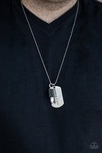 Load image into Gallery viewer, Pinched between a black leather fitting, a silver bullet pendant joins a silver dog tag at the bottom of a silver ball chain. The shimmery dog tag is stamped in the phrase, "Because of the Brave," for a patriotic finish. Features a ball and clasp closure. Sold as one individual necklace.