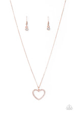 Load image into Gallery viewer, Encrusted in sparkly white rhinestones, an airy rose gold heart frame swings from a dainty rose gold chain below the collar for a romantic look. Features an adjustable clasp closure. Sold as one individual necklace. Includes one pair of matching earrings.