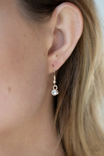 Load image into Gallery viewer, White rhinestone hanging from a rose gold fish hook earring.