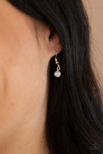 Load image into Gallery viewer, White bead hanging from a gold fish hook earring.