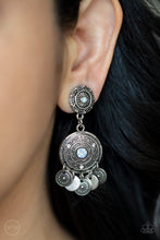 Load image into Gallery viewer, Dainty silver discs and antiqued floral frames dance from the bottom of an ornately embossed silver frame that links to a matching silver fitting. Both frames are dotted in blue opalescent rhinestone centers, while the largest of frames is sprinkled in dainty white rhinestone accents for a dreamy finish. Earring attaches to a standard clip-on fitting. Sold as one pair of clip-on earrings.