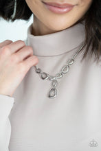 Load image into Gallery viewer, Irregular shaped silver rings connect to a sliver chain as they make their way across the collar. Two rings dangle from the center for a stylish avant-garde fashion. Features an adjustable clasp closure. Includes one pair of matching earrings.