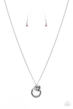Load image into Gallery viewer, Dotted with a sparkly pink rhinestone, a dainty silver heart joins a silver ring stamped in the biblical passage, "Trust in the Lord with all thine heart," and a silver disc stamped in, "Proverbs 3:5," along the bottom of a lengthened silver chain, creating an inspirational pendant. Features an adjustable clasp closure. Sold as one individual necklace. Includes one pair of matching earrings.