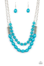 Load image into Gallery viewer, Infused with silver accents, rows of glassy and acrylic blue beads are threaded along invisible wires at the bottom of two silver chains that layer into a vivacious pop of color below the collar. Features an adjustable clasp closure. Includes one pair of matching earrings.