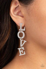 Load image into Gallery viewer, Silver letters with a lightly hammered sheen spell out the word "LOVE" as they vertically cascade down the ear in a flattering finish. Each of the letters are interconnected to one another giving the piece some whimsically playful movement. Earring attaches to a standard post fitting. Sold as one pair of post earrings.