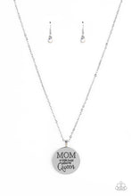 Load image into Gallery viewer, At the bottom of a shiny silver chain, a shiny silver disc is stamped with the phrase, "MOM a title just above Queen." The clasp attaching the disc to the chain features a collection of dainty iridescent rhinestones, adding a hint of sparkle to the sentimental statement piece. Features an adjustable clasp closure. Due to its prismatic palette, color may vary. Sold as one individual necklace. Includes one pair of matching earrings.