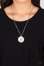 Load image into Gallery viewer, At the bottom of a shiny silver chain, a shiny silver disc is stamped with the phrase, "MOM a title just above Queen." The clasp attaching the disc to the chain features a collection of dainty iridescent rhinestones, adding a hint of sparkle to the sentimental statement piece. Features an adjustable clasp closure. Due to its prismatic palette, color may vary. Sold as one individual necklace. Includes one pair of matching earrings.