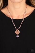 Load image into Gallery viewer, Infused along an invisible wire, copper beads and reflective pink, faceted beads glide down the chest in a shimmery style. Hanging from the bottom of the beads, a burnished copper disc is stamped with the phrase "God has a plan for YOU" with a reflective pink, faceted teardrop bead adding additional swing to the divine design. Features an adjustable clasp closure. Sold as one individual necklace. Includes one pair of matching earrings.