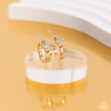 Load image into Gallery viewer, A shiny gold bar curls around the ear into a dainty hoop. Three gold stars gradually increase in size as they climb the curve of the hoop, with the biggest star emblazoned with white crystal-like rhinestones across its surface. Earring attaches to a standard post fitting. Hoop measures approximately 1/2" in diameter. Sold as one pair of hoop earrings.