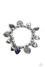 Load image into Gallery viewer, Decorative silver filigree, silver-studded, and blue gem heart charms swing from a collection of shiny silver beads, and silver beads with a dot motif. Threaded along an elastic stretchy band, the charming bracelet creates a timeless romantic centerpiece around the wrist. Sold as one individual bracelet.
