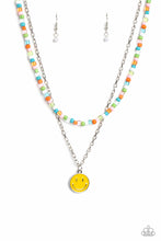 Load image into Gallery viewer, Gliding from a dainty, silver chain, a smiley face pendant stands out against a yellow backdrop. Completing the charismatic ensemble, a collection of seed beads in shades of baby pink, apple green, white, orange, and turquoise create bright pops of color around the neckline for a youthful finish. Features an adjustable clasp closure. Sold as one individual necklace. Includes one pair of matching earrings.