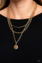 Load image into Gallery viewer, A trio of gold paperclip, classic, and oval link chains coalesces down the neckline for a monochromatic masterpiece. Strung on the lowermost oval link chain, a gold smiley face pendant, with a star mimicking a wink for one of its eyes, stands out and reflects light in every direction for a statement finish. Features an adjustable clasp closure. Sold as one individual necklace. Includes one pair of matching earrings.