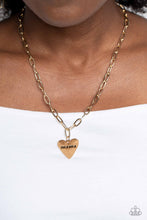 Load image into Gallery viewer, High-sheen gold ovals link down the chest drawing attention to the gold heart pendant at its bottom. Stamped with the word "mama" in its center, this monochromatic masterpiece gives off a simplistic, sentimental style. Features an adjustable clasp closure. Sold as one individual necklace. Includes one pair of matching earrings.
