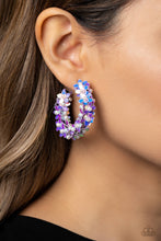 Load image into Gallery viewer, A floral explosion, encompassing the entirety of a thick silver hoop, features reflective lavender flowers dotted with dainty pearl centers for a dreamy, whimsicality below the ear. Earring attaches to a standard post fitting. Hoop measures approximately 1 1/2" in diameter. Sold as one pair of hoop earrings.