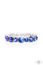 Load image into Gallery viewer, An assortment of oversized blue oil spill rhinestones are pressed into silver frames and threaded along stretchy bands, creating a blinding sparkle around the wrist. Due to its prismatic palette, color may vary. Sold as one individual bracelet.