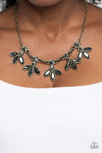 Load image into Gallery viewer, Featuring smoldering marquise style cuts, oversized smoky gems fan out from an interconnected, circular smoky rhinestone display. Separating the dauntless florals, airy brass ovals, stamped with a dot motif, create additional eye-catching sheen. Features an adjustable clasp closure. Sold as one individual necklace. Includes one pair of matching earrings.