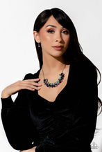 Load image into Gallery viewer, Featuring pronged silver fittings, a sparkly series of marquise-cut rhinestones in varying sizes and opacities are splashed in hues of purple, blue, light blue, baby pink, pink, and green as they fan out below the collar for a vibrant statement. Fuchsia and white round gems in varying sizes sporadically cluster around the marquise-cuts for additional shimmer in the geometric, refined display. Sold as one individual necklace. Includes one pair of matching earrings.