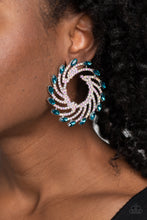 Load image into Gallery viewer, Shimmery strands of silver spin out from an airy center, creating an exaggerated firework-like display at the ear. An explosion of dainty iridescent rhinestones lines the swirls and curves of the shimmery display leading the eye to the collection of aquamarine marquise-cut gems at its ends. Each aquamarine marquise-cut gem curls around the ear in a clock-like manner, creating additional eye-catching dimension. Earring attaches to a standard post fitting. Sold as one pair of post earrings.