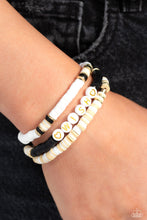 Load image into Gallery viewer, Varying in shades, tan, black, and white clay discs pair with shiny gold disc beads and accents creating layers across the wrist. Featured on one of the bracelets, white beads stamped with gold lettering spell out the word "wish," while gold heart silhouettes stamped in the same white beads frame the inspirational phrase for a wistful finish. Sold as one set of three bracelets.