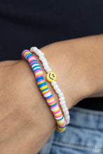 Load image into Gallery viewer, Hot pink, blue, white, and yellow clay discs combine with a strand of white seed beads to provide a vibrant pop of color along the wrist. Sporadically dotted in the high-sheen seed bead strand, yellow smiley face beads rest for a youthful finish on elastic stretchy bands.  Sold as one set of two bracelets.