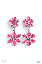 Load image into Gallery viewer, A hot pink transparent flower with pinched petals blooms around a glittery white gem center. The large flower swings from a second transparent hot pink flower, featuring a smaller size with fanned-out petals encircling a glittery white gem center. The elements combine to create a whimsical lure rich in character. Earring attaches to a standard clip-on fitting. Sold as one pair of clip-on earrings.