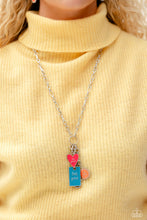 Load image into Gallery viewer, Featuring a glossy finish, a Pink Peacock heart, orange sun, and turquoise rectangle cascade from the bottom of a lengthened, trendy silver chain. Inscribed on each charm, the phrases "do good," "be good," and "feel good" create an inspirational finish to the uplifting display. A lobster clasp hangs from the bottom of the design to allow a name badge or other item to be attached. Features an adjustable clasp closure. Sold as one individual lanyard. Includes one pair of matching earrings.