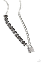 Load image into Gallery viewer, Infused on a classic silver chain, a strand of thick silver curb chain, and a collection of exaggerated, smoky radiant-cut gems in silver pronged fittings combine to create a collision of industrial color around the neckline. An oversized silver lock charm, embossed in white rhinestones, dangles from the gritty display for a touch of soft glitz to the design. Features an adjustable clasp closure. Sold as one individual necklace. Includes one pair of matching earrings.