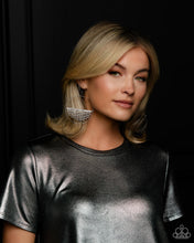 Load image into Gallery viewer, A curtain of white rhinestones is stretched between the edges of a skinny, oversized gunmetal hoop, creating a shimmering display. The rhinestones taper towards the center as they sway and cascade, adding sparkly movement for a fierce industrial finish. Earring attaches to a standard fishhook fitting. Sold as one pair of earrings.