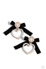 Load image into Gallery viewer, A solitaire white pearl, pressed in a white rhinestone-encrusted gold hoop, gleams atop a pearl-dotted heart frame resulting in a dazzling statement piece. A black velvet ribbon fans out from the pearly centerpiece further infusing the design with elegance. Earring attaches to a standard post fitting. Sold as one pair of post earrings.