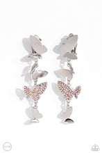 Load image into Gallery viewer, Three butterflies with high-sheen silver wings and one pink iridescent-encrusted butterfly flutter down the ear, creating a free-spirited lure. Each butterfly swings in whimsical asymmetry, creating the look of butterflies flying in alternating directions. Earring attaches to a standard clip-on fitting. Due to its prismatic palette, color may vary. Sold as one pair of clip-on earrings.