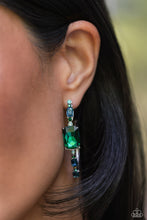 Load image into Gallery viewer, Encrusted in round and emerald-cut aquamarine and emerald gems, some featuring an iridescent sheen, an exaggerated oblong silver hoop curls around the ear, refracting light in a dramatic, knockout finish. Earring attaches to a standard post fitting. Hoop measures approximately 2" long. Due to its prismatic palette, color may vary. Sold as one pair of hoop earrings.