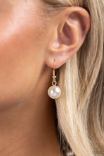 Load image into Gallery viewer, White pearls trickle below the collar attaching to a gold hoop as it nears the center of the chest. Accented with oversized white pearls, rhinestone-encrusted gold beads, faceted clear beads, and strands of gold chains cascade from the bottom of the gold hoop creating a charming, refined display. Features a clasp closure. Sold as one individual necklace. Includes one pair of matching earrings.