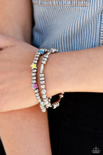 Load image into Gallery viewer, A strand of textured, cylindrical, and round high-sheen silver beads combine with a single strand of silver beads, sporadically infused with vivacious charm beads to create an energetic stack of stretchy bracelets. The colorful beaded stack features a yellow star, blue lightning bolt, green money bag, orange tropical flower, red lips, blue and green earth, pink and purple flower, and a pink heart charm with the words "love me" for a youthful finish. Sold as one set of two bracelets.
