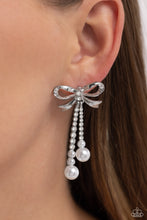 Load image into Gallery viewer, Adorned in sparkling white rhinestones, high-sheen bands of silver curl and loop into a stunning bow charm, creating a classy statement at the ear. White rhinestones encased in scalloped silver fittings, featuring white pearls that slowly increase in size dangle from the bow charm adding a refined tassel to the stunning display. Earring attaches to a standard post fitting. Sold as one pair of post earrings.