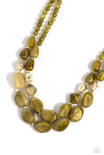 Load image into Gallery viewer, Varying in shape and opacity, a refreshing collection of sparkle-infused green beads layer below the collar for a boldly colorful look. Accents of faceted gold beads and gold studs are infused throughout the design for a subtle touch of additional sheen. Features an adjustable clasp closure. Sold as one individual necklace. Includes one pair of matching earrings.