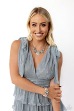 Load image into Gallery viewer, Sleek metal bars flare out from a mesmerizing pearl center, creating a blue and white stacked rhinestone-encrusted fringe of fanning frames. A trio of emerald-cut white gem bars are sprinkled across each dazzling display for a sassy finish. Strung along elastic stretchy bands, three bands of pearls wrap around the wrist. Featured atop the pearly collection, sleek metal bars flare out from a mesmerizing pearl center, creating a stacked blue and white rhinestone-encrusted fringe of fanning frames.