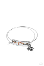 Load image into Gallery viewer, The word "BeYOUtiful" is stamped across a thick plate of silver, with the "YOU" in a playful orange font. A textured, silver lotus flower charm gathers at the side of the inspirational centerpiece as it connects to a skinny silver bar that wraps around the wrist. Features a hook and eye closure. Sold as one individual bracelet.