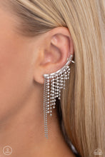 Load image into Gallery viewer, A tapered fringe of dainty silver popcorn chains and glittery strands of white rhinestones in square fittings cascades from the edge of a white emerald-cut, gem-encrusted curved frame, creating an edgy centerpiece. Earring attaches to a standard post earring. Features a clip-on fitting at the top for a secure fit. Sold as one pair of ear crawlers.