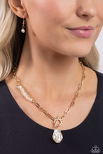 Load image into Gallery viewer, Featuring an elegant lariat closure, an oversized, baroque white pearl cascades from the bottom of a gold paperclip chain for a refined fashion. Dainty, glossy baroque pearl beads are infused along one side of the gold chain for an additional touch of abstract sheen to the charming design. Sold as one individual necklace. Includes one pair of matching earrings.