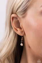 Load image into Gallery viewer, Featuring an elegant lariat closure, an oversized, baroque white pearl cascades from the bottom of a gold paperclip chain for a refined fashion. Dainty, glossy baroque pearl beads are infused along one side of the gold chain for an additional touch of abstract sheen to the charming design. Sold as one individual necklace. Includes one pair of matching earrings.