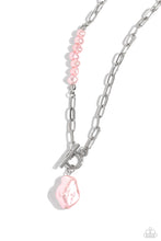 Load image into Gallery viewer, Featuring an elegant lariat closure, an oversized, baroque baby pink pearl cascades from the bottom of a silver paperclip chain for a refined fashion. Dainty, glossy baroque baby pink pearl beads are infused along one side of the silver chain for an additional touch of abstract sheen to the charming design. Sold as one individual necklace. Includes one pair of matching earrings.