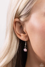 Load image into Gallery viewer, Featuring an elegant lariat closure, an oversized, baroque baby pink pearl cascades from the bottom of a silver paperclip chain for a refined fashion. Dainty, glossy baroque baby pink pearl beads are infused along one side of the silver chain for an additional touch of abstract sheen to the charming design. Sold as one individual necklace. Includes one pair of matching earrings.