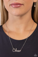Load image into Gallery viewer, Curled in a script font, glistening silver letters spell out the word "Cheer" along a dainty silver chain. Embossed on the letters, dainty white rhinestones and iridescent rhinestones create a subtle ombré effect for a peppy finish. Features an adjustable clasp closure. Due to its prismatic palette, color may vary. Sold as one individual necklace. Includes one pair of matching earrings.